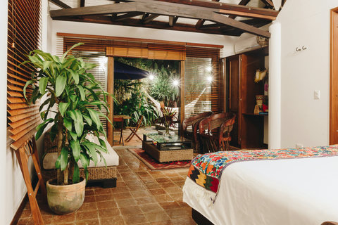 Bedroom 3  - 🌿 Escape to your tropical oasis! This charming retreat invites you to unwind under gentle, ambient lighting and vibrant decor. Enjoy evenings in the lush garden patio, perfect for those serene hammock moments or a cozy dinner al fresco. ✨