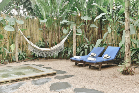 Patio - ✨ Escape to a tropical oasis where relaxation meets luxury! 🌿 Bask in the glow of string lights as you unwind in the hammock, or take a dip in the hot tub surrounded by lush greenery. Your serene retreat awaits! 🌺💫
