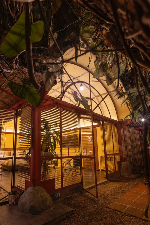 Patio Exterior View - Step into your own serene sanctuary, where warm hues and ambient lighting embrace nature’s touch. Enjoy the perfect blend of comfort and tranquility, with lush greenery and modern amenities inviting you to unwind and relax in style.