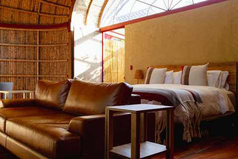 Bedroom 3 - Step into a cozy retreat where rustic charm meets modern comfort. Bathed in warm, glowing lights, this inviting sanctuary offers plush seating for relaxation and a serene ambiance for a restful night's sleep. Embrace the soothing vibes and unw