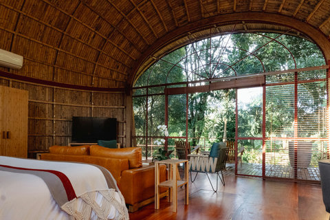 Bedroom 3 - Step into tranquility with this enchanting retreat, where natural light dances through panoramic windows, revealing serene forest views. Unwind in cozy seating, sip morning coffee on the inviting patio, and let the soothing ambiance rejuvenate