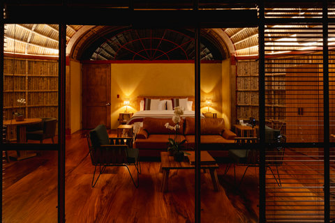 Bedroom 3 - Step into serenity with our warm, softly lit retreat, where rustic elegance meets modern comfort. Enjoy the cozy seating, ambient lighting, and inviting atmosphere—your perfect escape awaits.