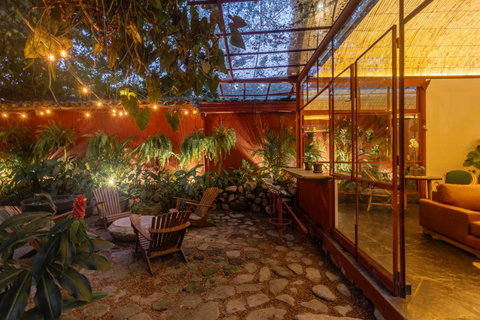 patio - Step into your own tropical oasis where lush greenery meets cozy charm. Relax under the twinkling lights and embrace the warm glow of this serene hideaway, perfect for evening gatherings and morning coffee moments. 🌿✨