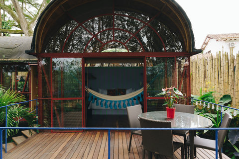 Terrace -Escape to a tranquil oasis where rustic charm meets modern comfort. Bask in the warm, natural light pouring through panoramic windows, and unwind on your private deck. With a cozy hammock swinging gently under the lush greenery, relaxation has ne