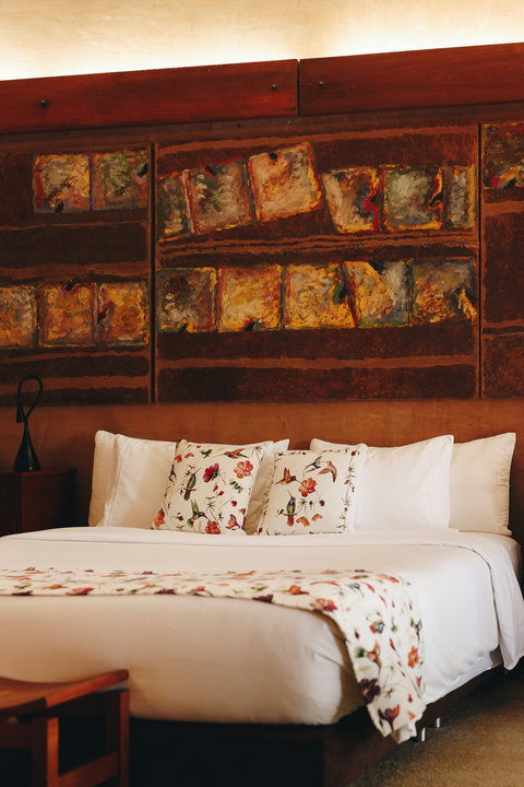 Bedroom 2 - Escape into warmth and luxury with our beautifully lit, rustic retreat. Admire the artful decor while sinking into the comfort of our spacious king bed. Perfect for unwinding, the cozy reading nook and entertainment center promise endless rela