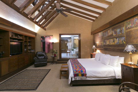 Bedroom 2 - Step into a sanctuary of tranquility and warmth, where the soft glow of ambient lighting meets rustic elegance. This inviting retreat boasts high beam ceilings and plush amenities, offering the perfect blend of comfort and style for a rejuvena