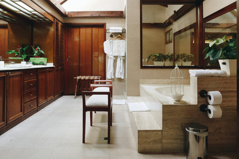 Bathroom - Step into a serene oasis where natural light dances off rich wooden accents, inviting you to unwind. Relax in style with luxurious amenities and thoughtful details that create a spa-like retreat, perfect for rejuvenating your senses.