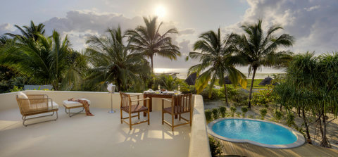 As golden light softens the palms, dinner upstairs feels intimate, unhurried, and quietly unforgettable above the water.