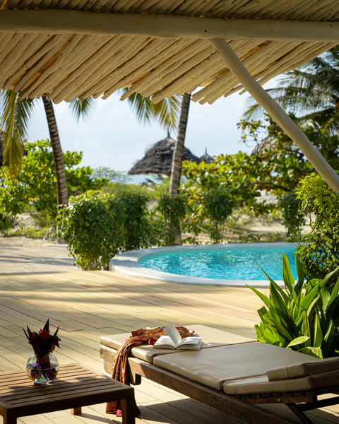 Slow afternoons land differently here, book in hand, breeze in the palms, and the pool shimmering just a few steps away.