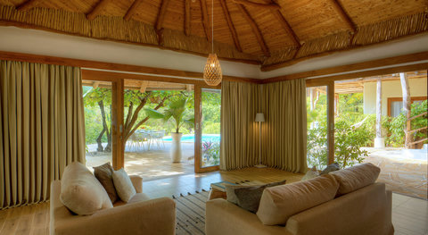 Settle into soft shade and warm timber, where the garden drifts in and the day starts to slow.