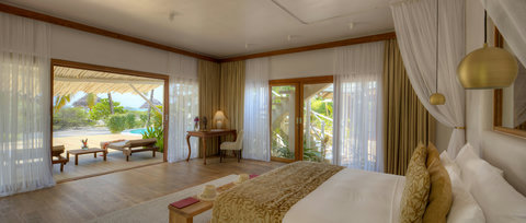 Wake to soft drapes, crisp linen, and a glimpse of turquoise, with the terrace already calling you outside.