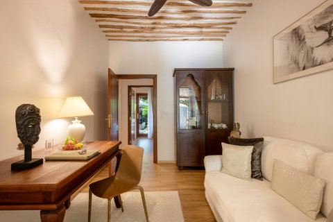 Beyond the bedroom, a quiet corner holds space for writing, reading, or simply lingering with the day half open.