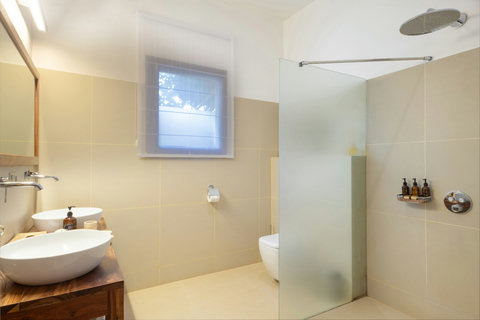Inside, stone, glass, and softened light turn the simplest morning ritual into something unhurried, clean, and deeply calming.