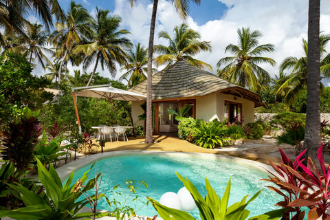 Afternoon gathers around the pool, bright and easy, with soft shade nearby and the hush of tropical gardens all around.