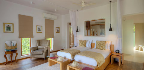 The room welcomes rest without asking for it, all crisp linen, soft light, and space to exhale completely.