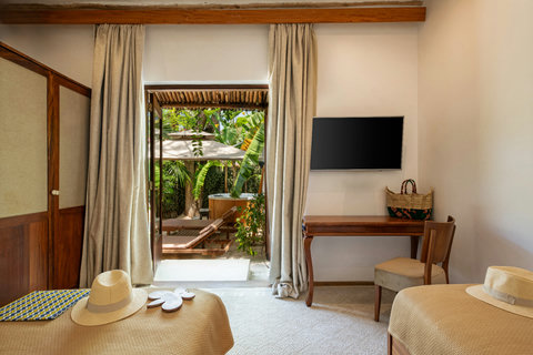 Curtains part, the terrace glows, and the room settles into that first exhale of barefoot ease.