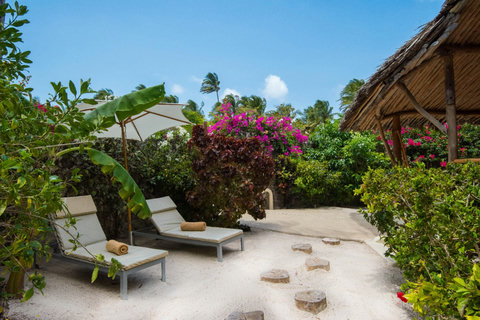 Outside, soft sand underfoot and a private pocket of shade invite the first long pause of the day.