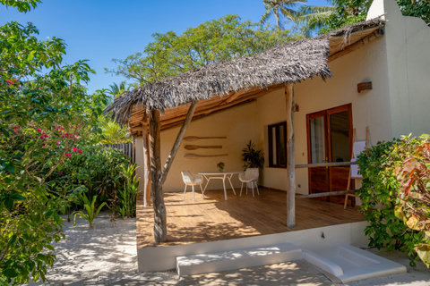 The villa waits in open shade, all sun-warmed textures, bare feet, and the easy rhythm of doing less.