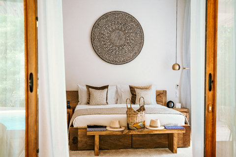 Through open doors, the bed faces the pool’s shimmer, a private pause between swim and nap.
