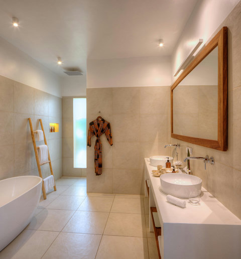 Sink, mirror, and morning glow, everything pared back so the senses can finally rest.