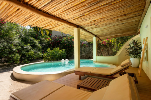 Dappled garden light drifts across the pool, floaters bob softly, time loosening with every sip.