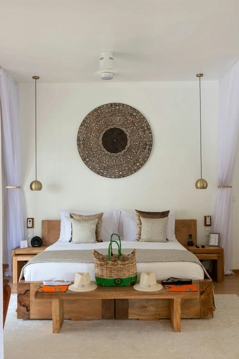 Fresh linens, woven basket, and a last slow exhale, the room settling into evening peace.