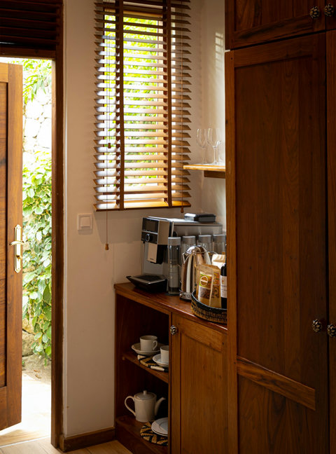 Coffee waits by the window, blinds casting gentle lines, a small ritual before the world wakes.