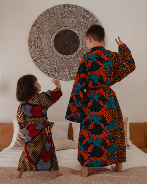 Afternoons feel lighter here, with bare feet on the bed and playful moments wrapped in color and ease.