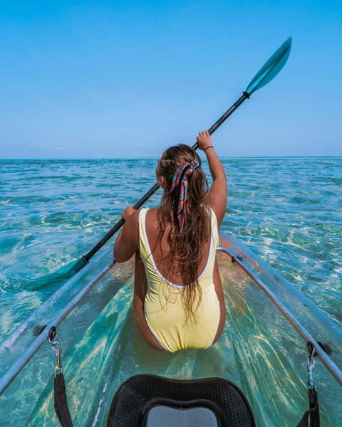 Glide over clear shallows, paddle dipping softly, the sea opening wide in front of you.