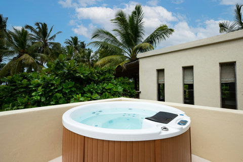 Slip into warm water under open sky, bubbles rising as the island air turns your shoulders weightless.