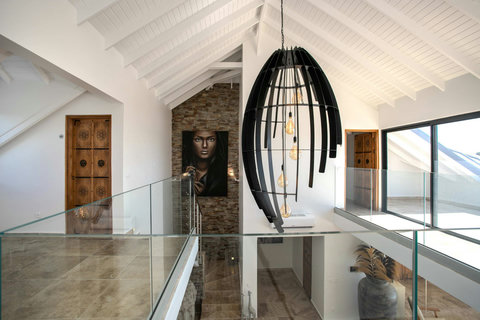 Stairs showing the entrance of bedroom 4 (door on the left with access to the balcony).