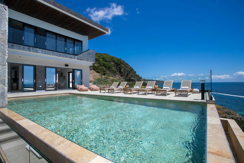 Swimming Pool, Sun Chairs, and the Villa