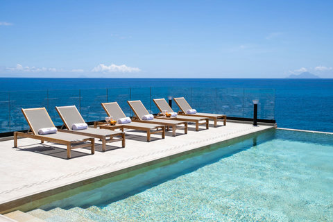 Swimming Pool with Sun Chairs and Ocean View and Saba in the Background