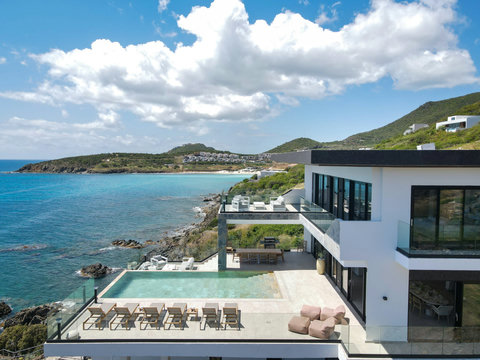 Villa View from the Side with Indigo Bay in Background