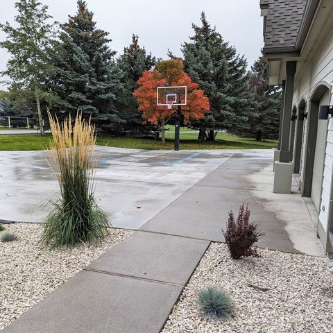 Front yard features a basketball hoop with painted lines in front of the 3 car garage.