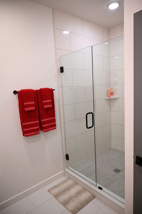 Huge walk in shower with glass shower door.