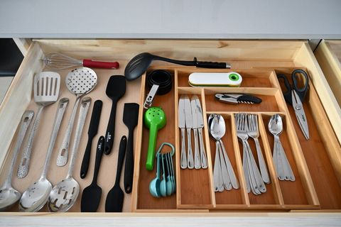 Fully stocked utensils, pots, pans, and cooking gear.