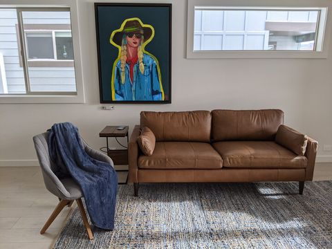 Living room features gorgeous original artwork by local Bozeman artists and genuine leather couch.