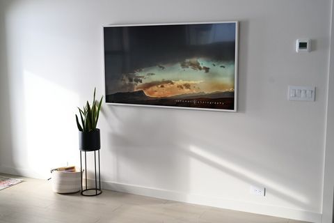 Living room features a 65" Samsung The Frame television showcasing Bozeman area photography. Streaming services logged in on Netflix, Hulu, and Disney Plus.