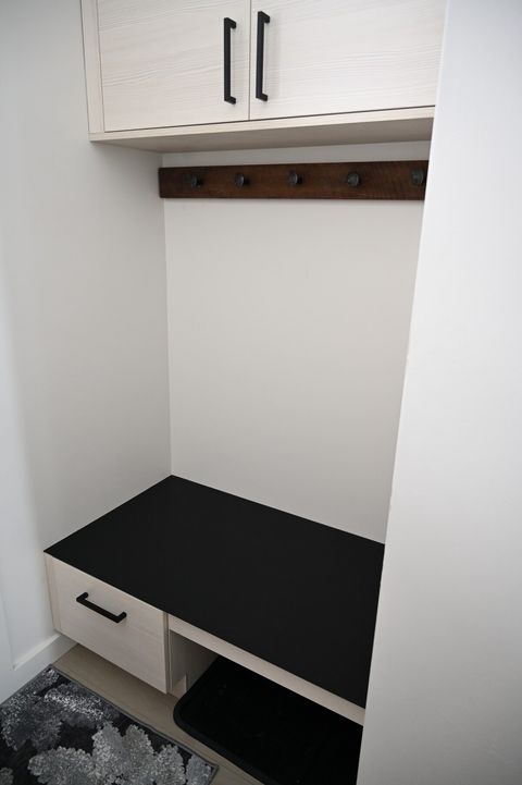 entry way with coat hooks and bench to take on and off your shoes