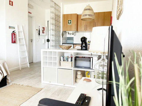 Studio: View to mid-room shelf, kitchen and entry.