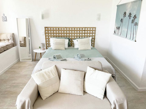 Studio: Front view to queen bed.