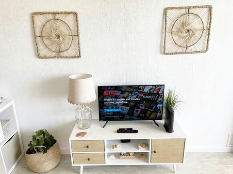 Studio: Front view to TV console and decoration.
