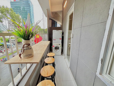 Convenient balcony space featuring a private washing machine and dryer, ideal for longer visits. This setup minimizes laundry noise during indoor relaxation, enhancing guest comfort. Enjoy the fresh air while managing laundry effortlessly 