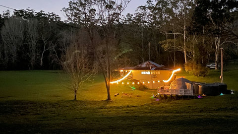 The room is located where the lights on the main building are. You can see The Burrow Glamping Dome in the foreground. This is great to book alongside the room for 6-8 guests.