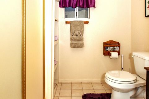 Bathroom is on Balcony level. Shower, at left, has seat and grab bar. Several cubbies hold extra towels.