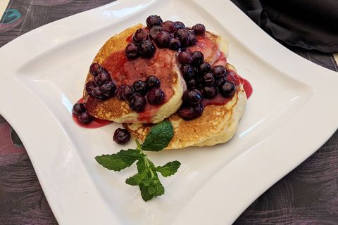 Light and fluffy lemon ricotta pancakes with warm blueberry sauce - perfect for a Sunday brunch! Please inquire about menu, pricing, and availability.