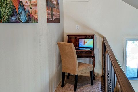 Comfortable chair, desk, charging station on quiet balcony.