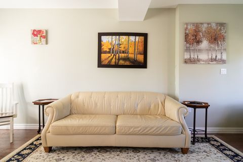 One of Two Leather Couches in Living Area