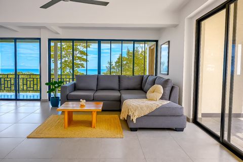 Living Room: Bright and airy space with ocean views and a plush sectional for ultimate relaxation!
